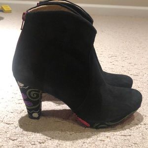 Black bootie with red sole and embroidered heel
